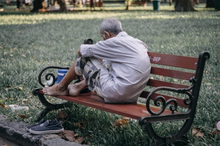Homeless person on a park bench