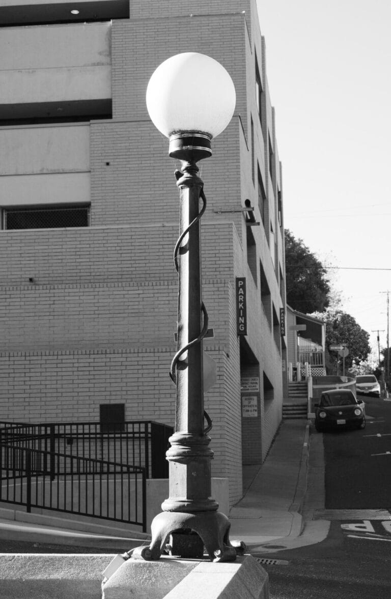 Light pole in front of parking garage.